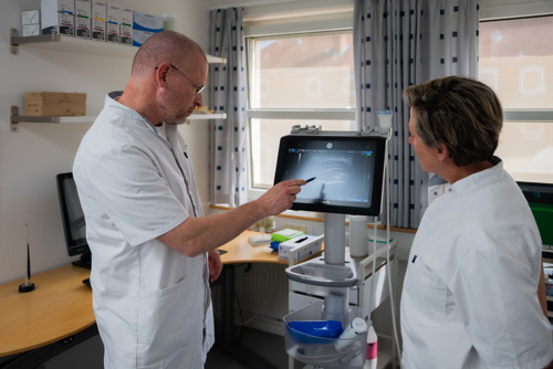 Michael Møller viser noget på ultralydsapparat - Botox behandling